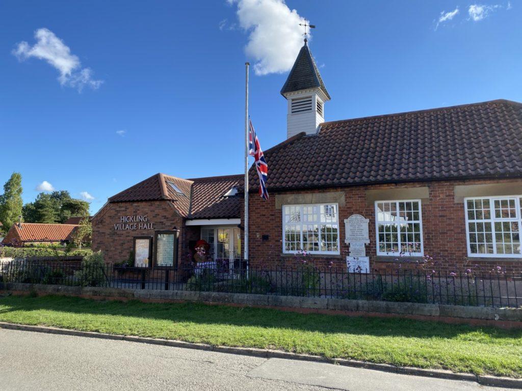 The flag flies at half-mast outside Hickling Village Hall